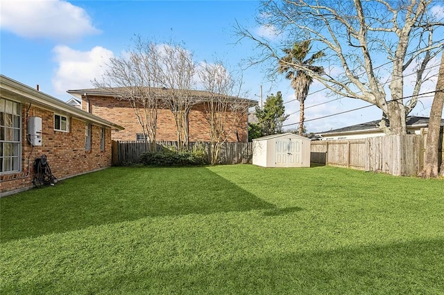 view of yard featuring a shed, a fenced backyard, and an outdoor structure