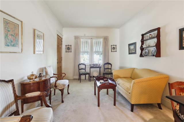 sitting room featuring light colored carpet