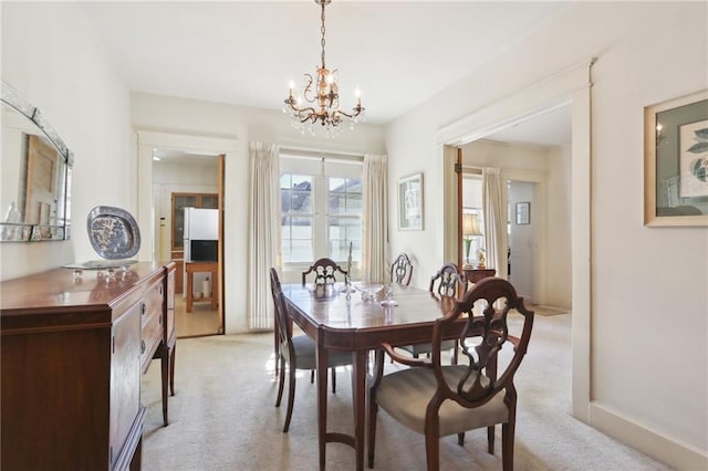 dining area featuring light carpet and a notable chandelier