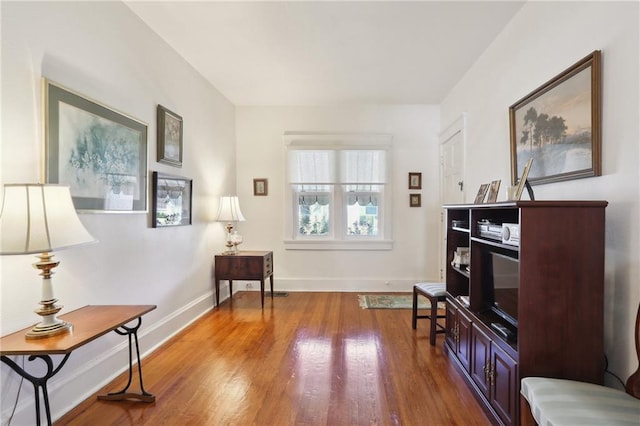 sitting room with wood finished floors and baseboards