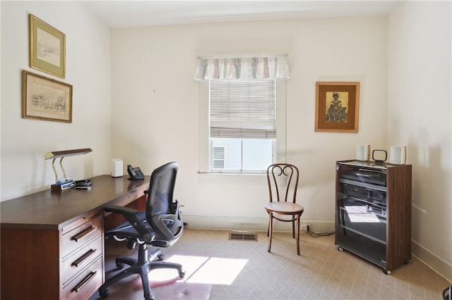 home office featuring baseboards, visible vents, and light colored carpet