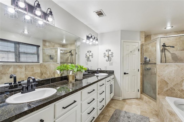 bathroom featuring a shower stall, visible vents, and a sink