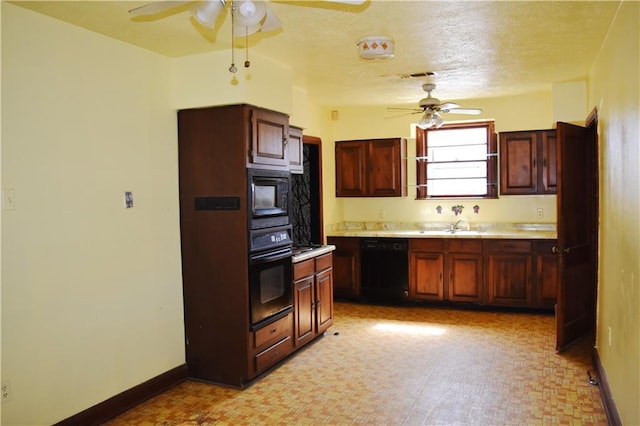 kitchen featuring baseboards, light countertops, a textured ceiling, and black appliances