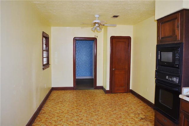 interior space featuring light floors, visible vents, a textured ceiling, and baseboards