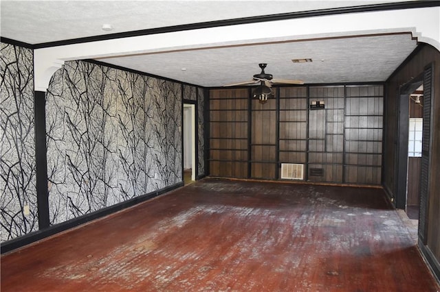 unfurnished living room with hardwood / wood-style flooring, visible vents, and crown molding