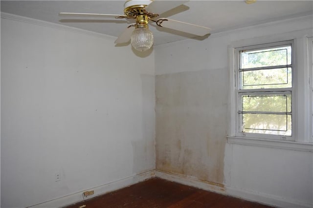 empty room with baseboards, dark wood-style flooring, plenty of natural light, and crown molding