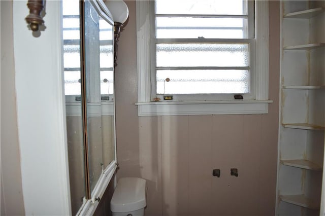 bathroom with toilet and a shower