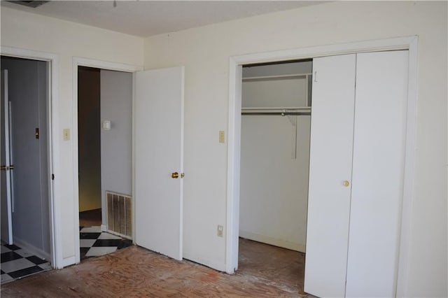 unfurnished bedroom featuring visible vents and tile patterned floors