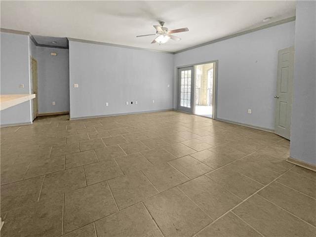 spare room with ornamental molding, tile patterned flooring, baseboards, and a ceiling fan