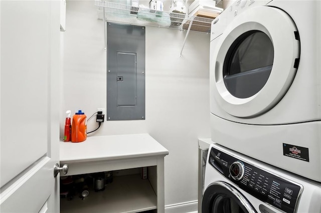 clothes washing area featuring electric panel, stacked washer and clothes dryer, and laundry area