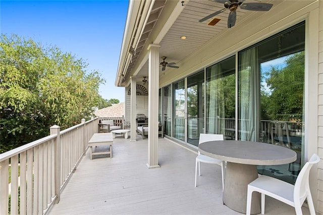 wooden terrace with a ceiling fan