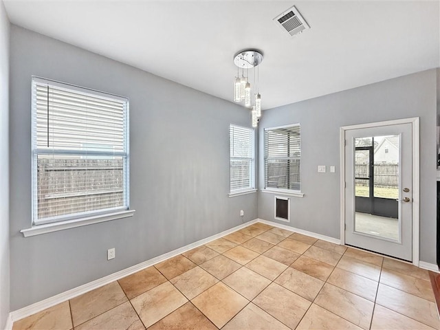 unfurnished room featuring light tile patterned floors, visible vents, and baseboards