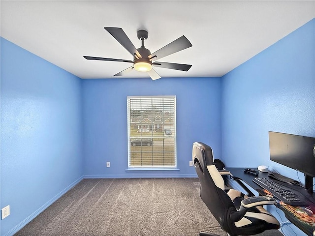 unfurnished office with carpet, a ceiling fan, and baseboards