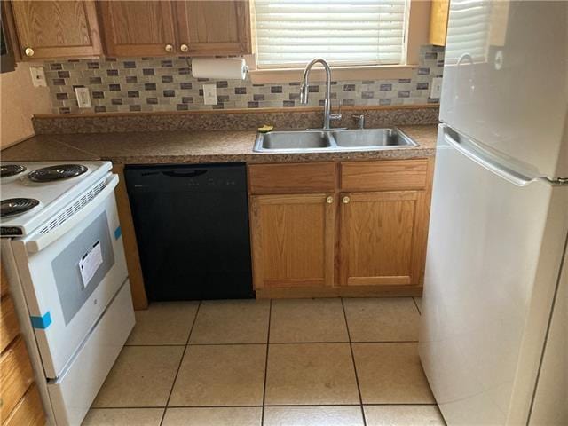 kitchen featuring white appliances, light tile patterned floors, backsplash, and a sink