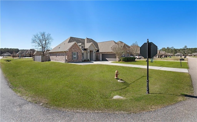 view of front of home with driveway, an attached garage, and a front lawn