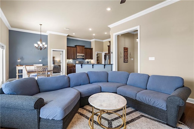 living area with recessed lighting, an inviting chandelier, ornamental molding, wood finished floors, and baseboards