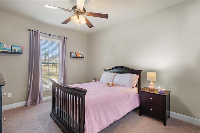 bedroom with baseboards, a ceiling fan, and light colored carpet