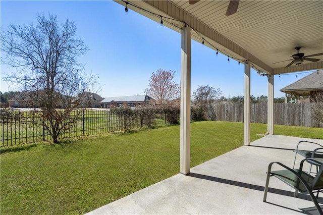 view of yard featuring ceiling fan, a fenced backyard, and a patio