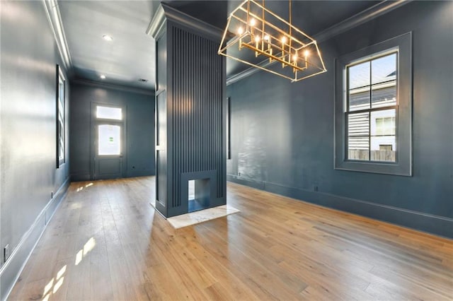 unfurnished room featuring ornamental molding, recessed lighting, hardwood / wood-style flooring, and baseboards