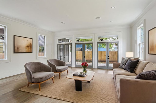 3324 Camp St, New Orleans, LA 70115 - living room with french doors, wood finished floors, ornamental molding, recessed lighting, and baseboards