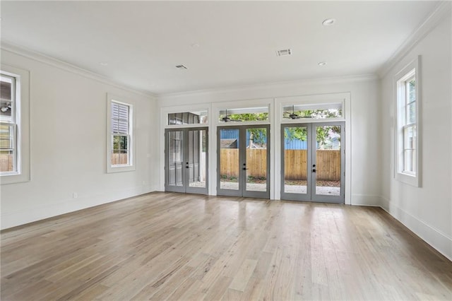 3324 Camp St, New Orleans, LA 70115 - empty room featuring french doors, light wood-style floors, crown molding, baseboards, and recessed lighting