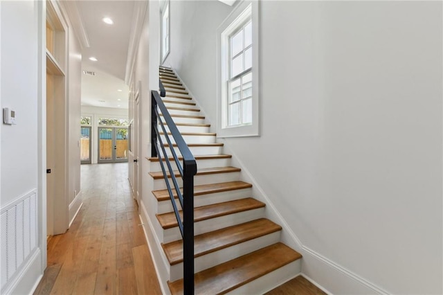 stairs featuring recessed lighting, visible vents, baseboards, french doors, and wood-type flooring