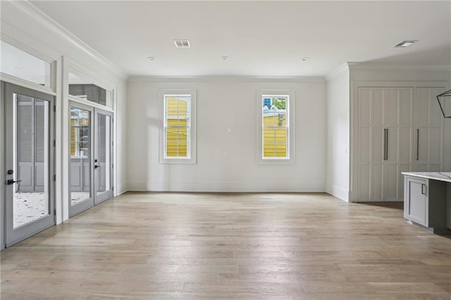 3324 Camp St, New Orleans, LA 70115 - unfurnished living room with ornamental molding and light wood-style flooring