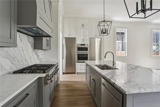 3324 Camp St, New Orleans, LA 70115 - kitchen featuring stainless steel appliances, extractor fan, backsplash, dark wood finished floors, and gray cabinetry