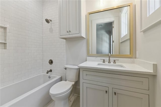 bathroom with shower / bath combination, vanity, and toilet