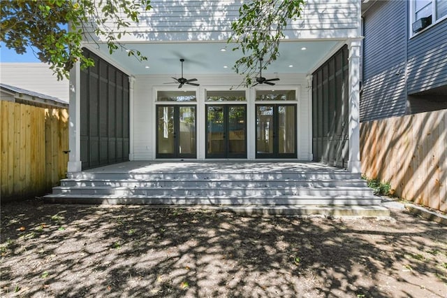 exterior space with ceiling fan, fence, a deck, and french doors