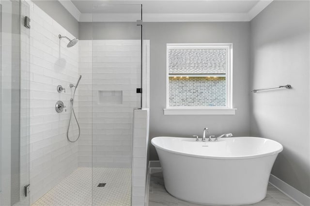 bathroom featuring a freestanding bath, a shower stall, and baseboards