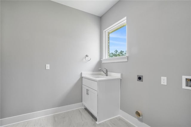 bathroom with marble finish floor, vanity, and baseboards