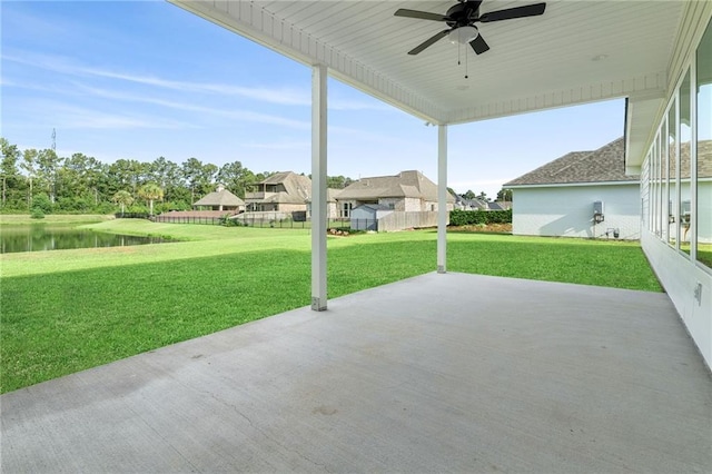 view of patio / terrace with ceiling fan and a water view