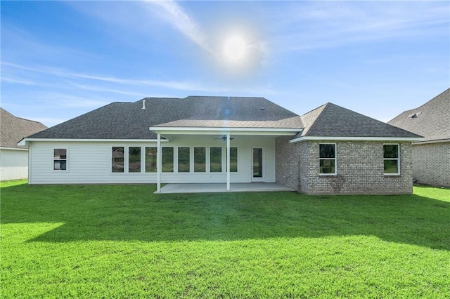 back of house featuring a patio area, a yard, a shingled roof, and ceiling fan