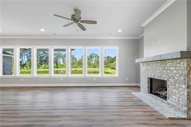 unfurnished living room featuring ornamental molding, ceiling fan, baseboards, visible vents, and a fireplace with flush hearth