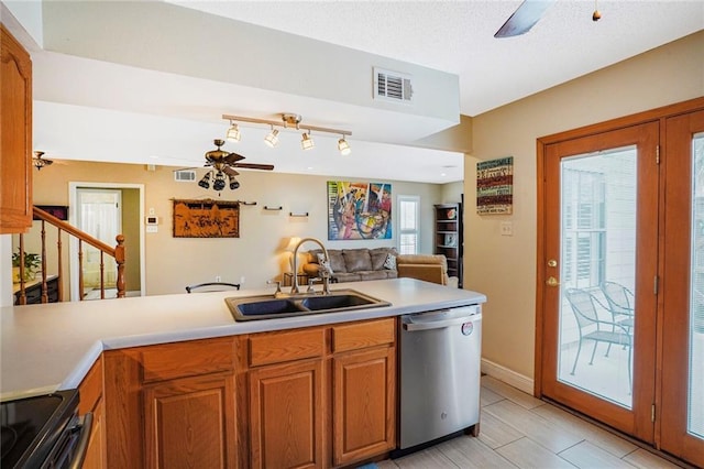 kitchen with visible vents, stainless steel dishwasher, brown cabinetry, a sink, and ceiling fan