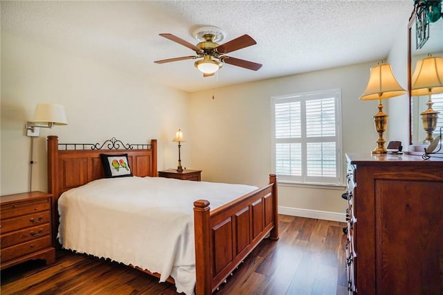 bedroom featuring dark wood-type flooring, a textured ceiling, and baseboards