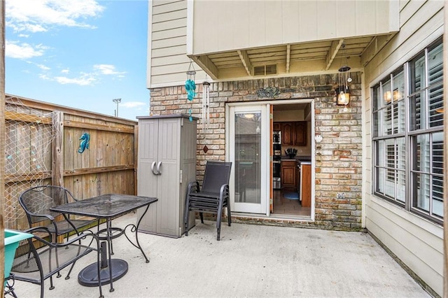 view of patio / terrace featuring fence