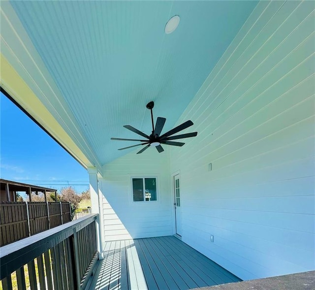 wooden terrace featuring fence and a ceiling fan