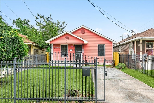 bungalow-style home featuring a fenced front yard, covered porch, a front lawn, and a gate