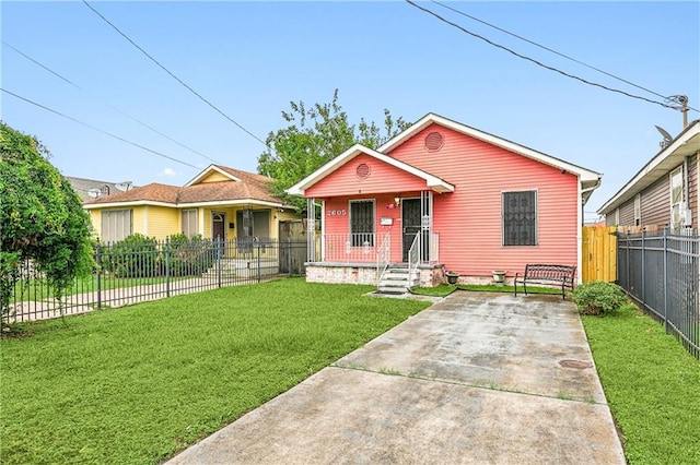 view of front of property with covered porch, a front yard, and fence private yard