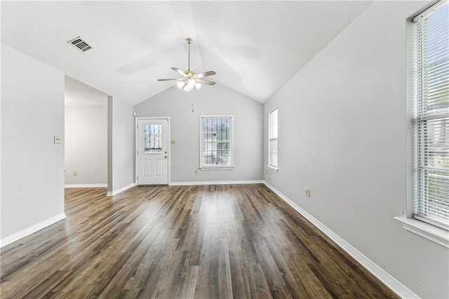 interior space with lofted ceiling, baseboards, visible vents, and wood finished floors