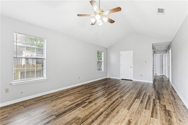 unfurnished bedroom with lofted ceiling, multiple windows, visible vents, and wood finished floors