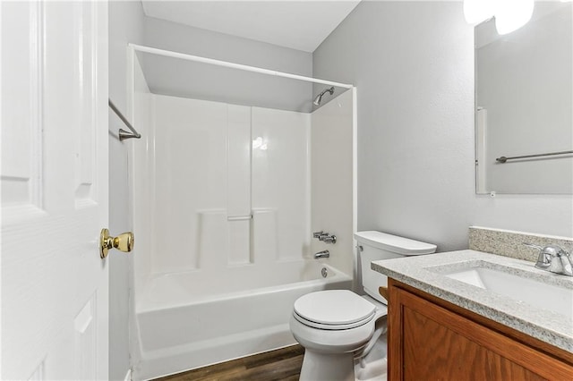 bathroom featuring tub / shower combination, vanity, toilet, and wood finished floors