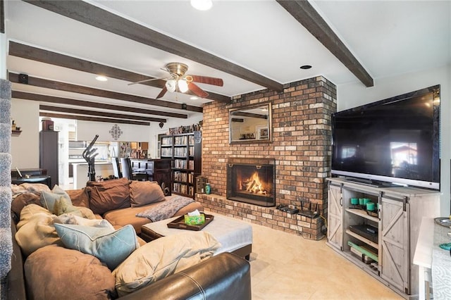 living area with ceiling fan, a fireplace, and beam ceiling