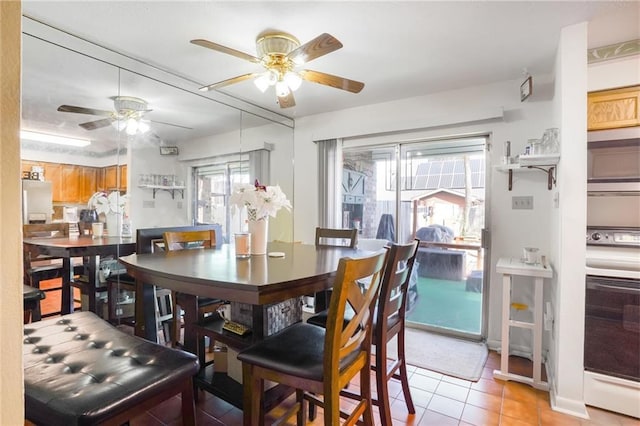 dining room with a ceiling fan and light tile patterned flooring