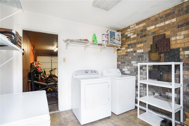 clothes washing area featuring laundry area and washer and clothes dryer