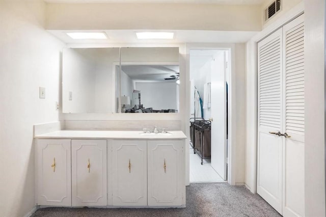 bathroom featuring a ceiling fan, visible vents, and vanity