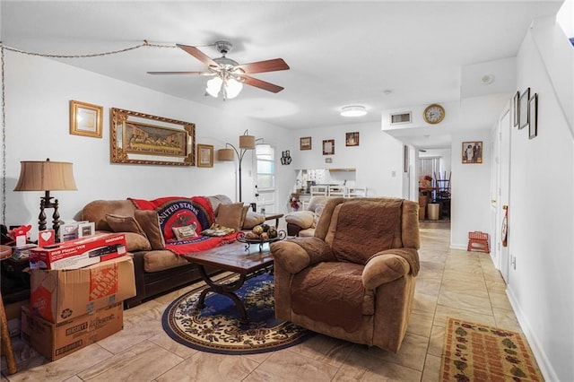 living area featuring visible vents, ceiling fan, and baseboards