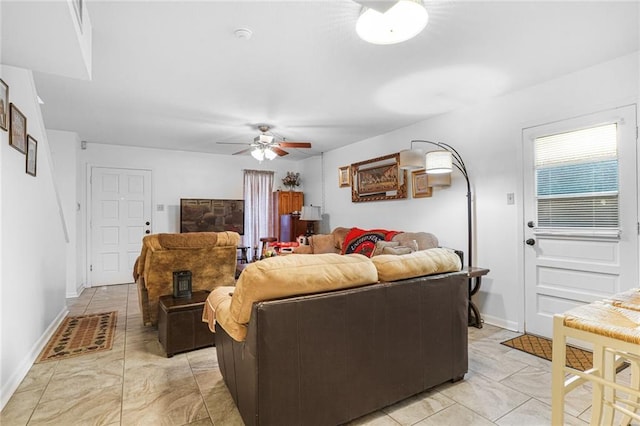 living room featuring ceiling fan and baseboards